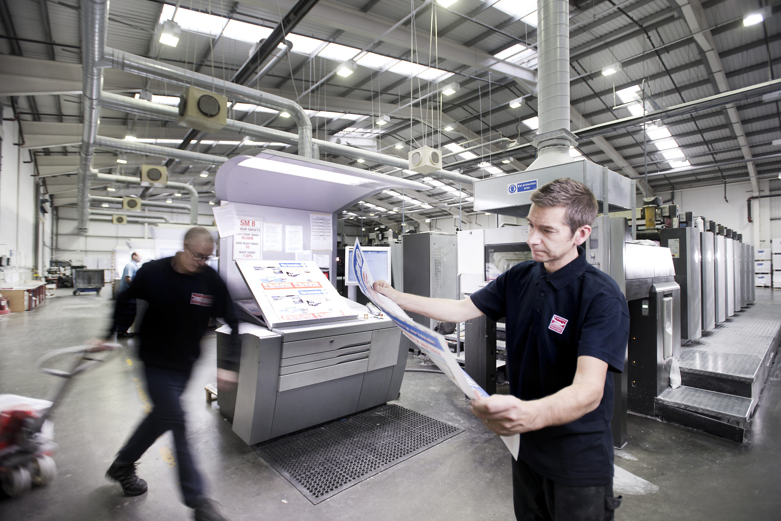 Bishops print staff checking a printed sheet